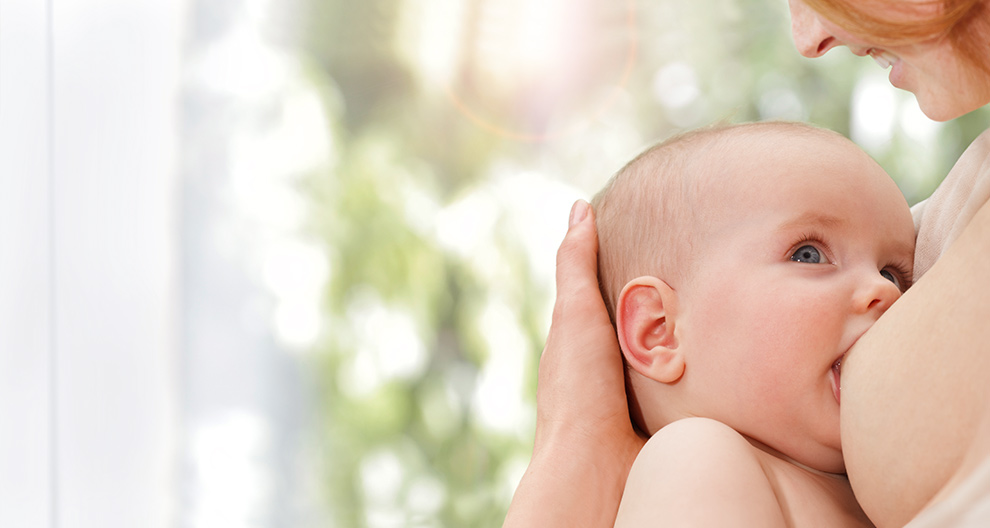 A mother breastfeeds her baby.
